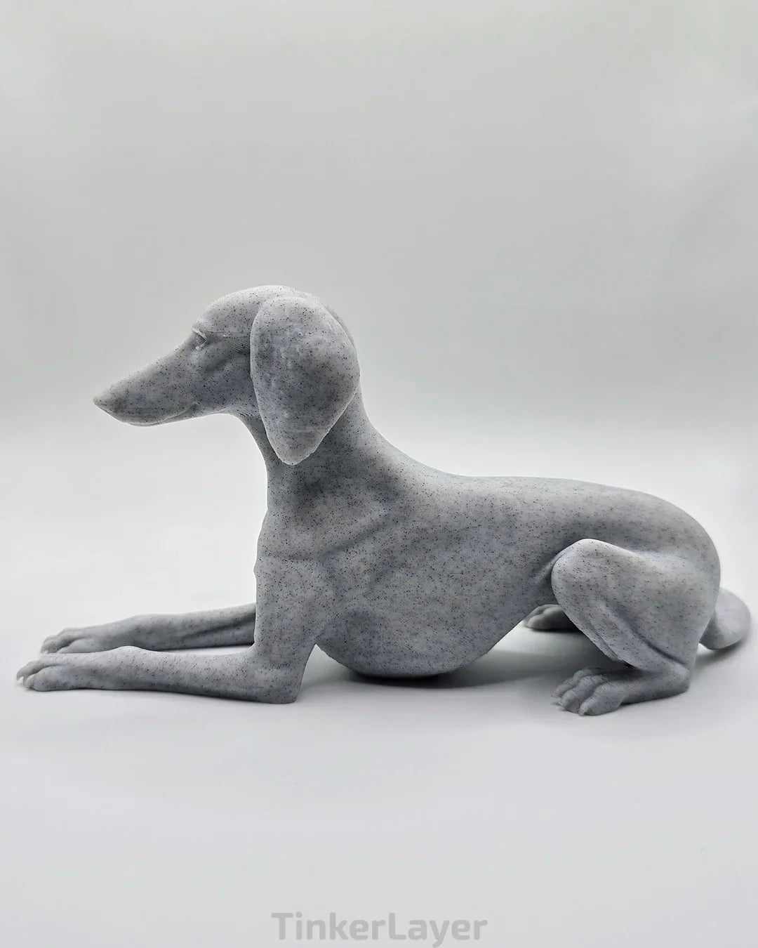 Side view of laying Saluki statue in marble PLA