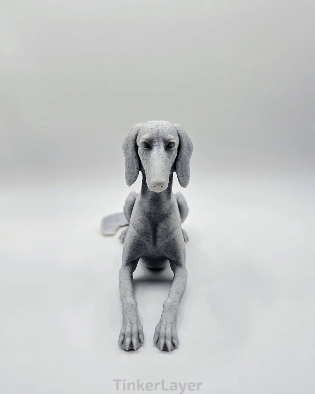 Front view of laying Saluki statue in marble PLA