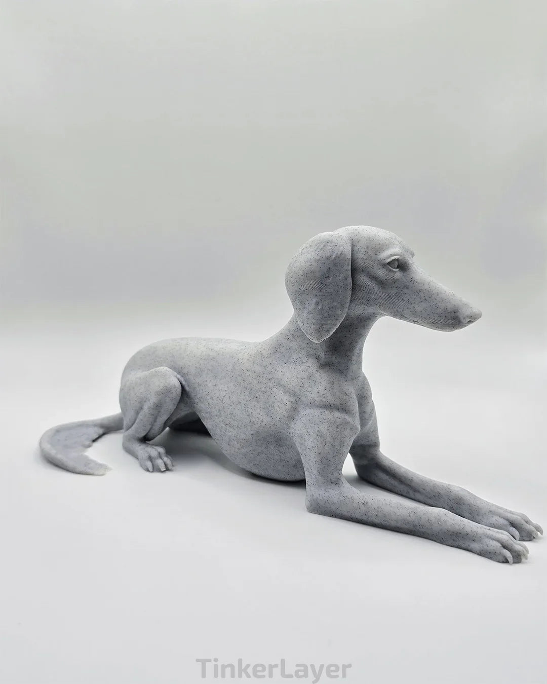 Side view of laying Saluki statue in marble PLA