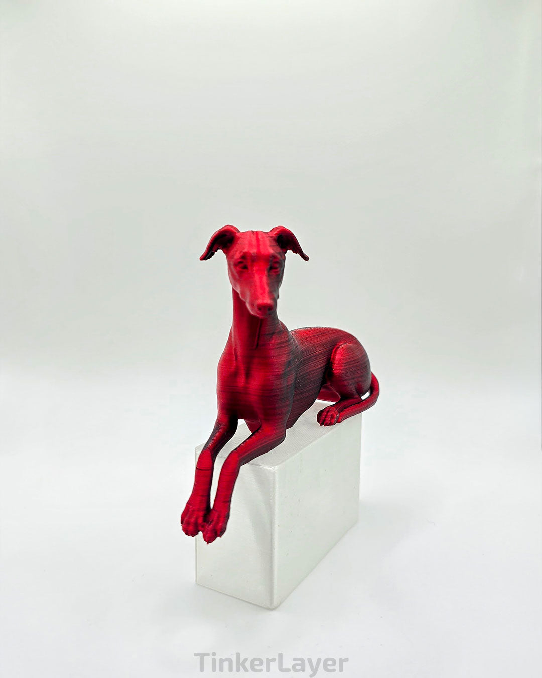 Whippet Shelf Lounger in Matte Black Red, bent legs, left facing